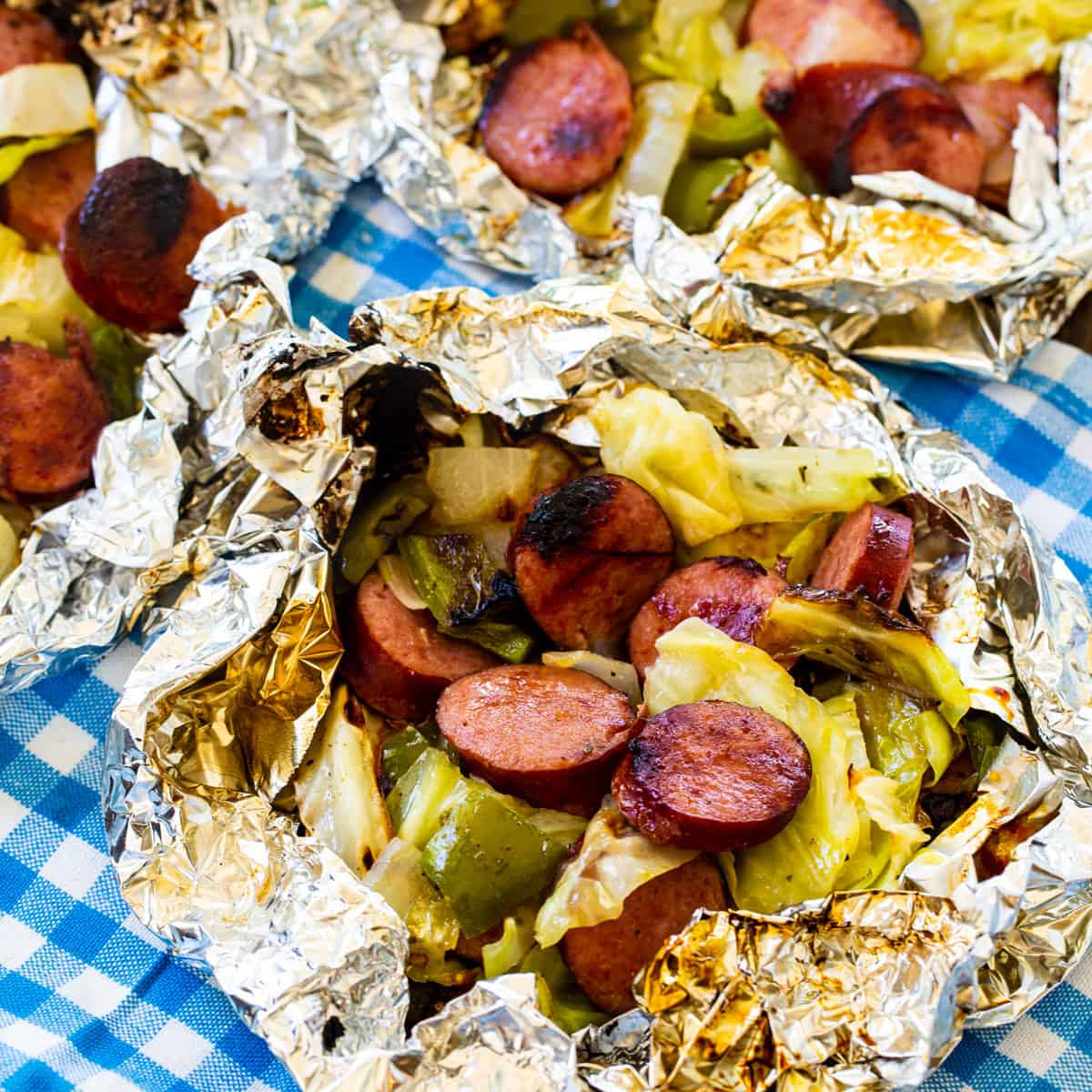 Keto Cabbage and Sausage Foil Packs on a blue and white cloth napkin.
