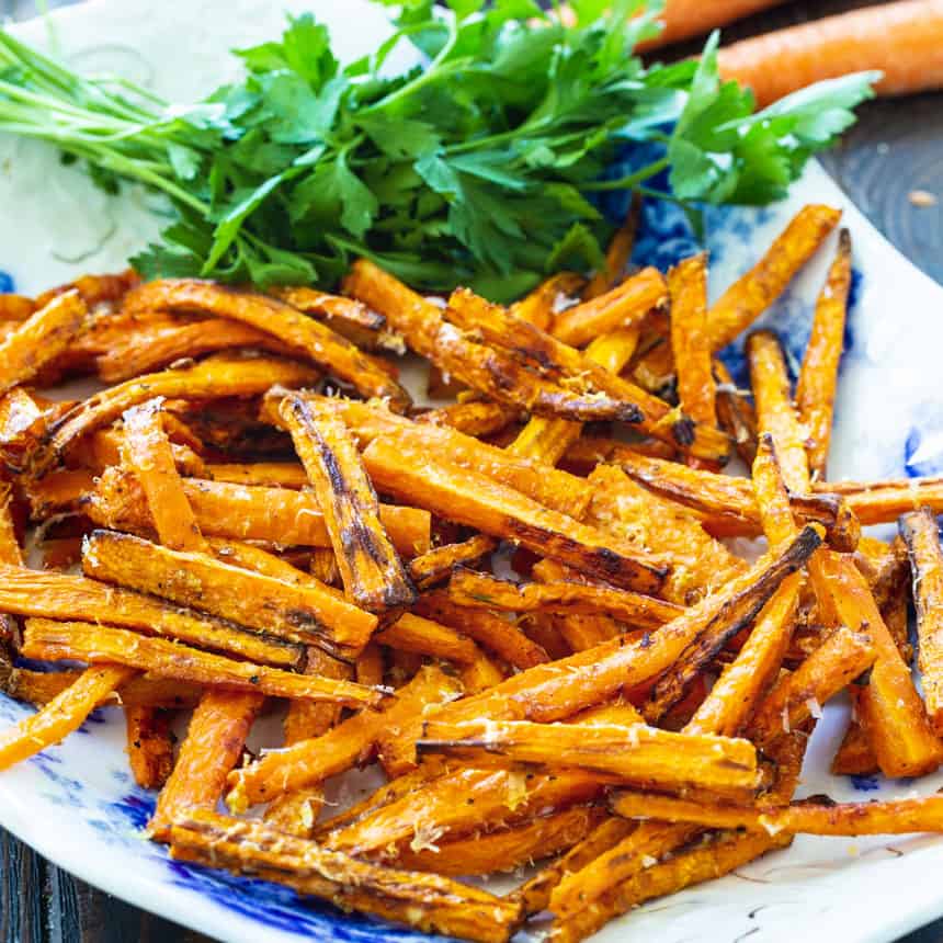 Carrot Fries on a serving plate with parsley.