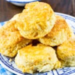 Air Fryer Buttermilk Biscuits stacked on a plate.