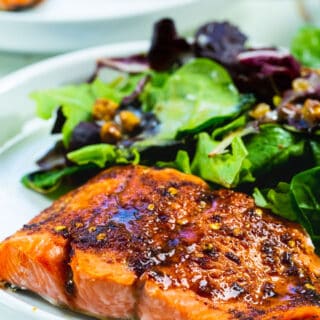 Air fried salmon on a plate with salad.
