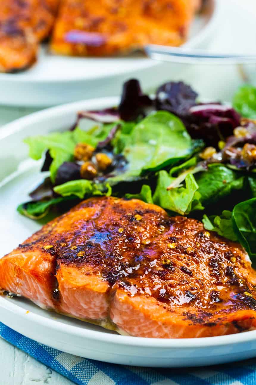 Air fried salmon on a plate with salad.