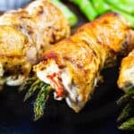 Chicken Asparagus and Goat Cheese Chicken Roll-ups on a cutting board.