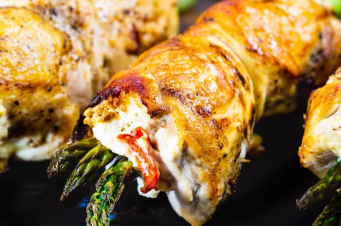 Chicken Asparagus and Goat Cheese Chicken Roll-ups on a cutting board.