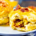 Air Fryer Bacon Egg & Cheese Biscuits Bombs with bite bitten to show inside.