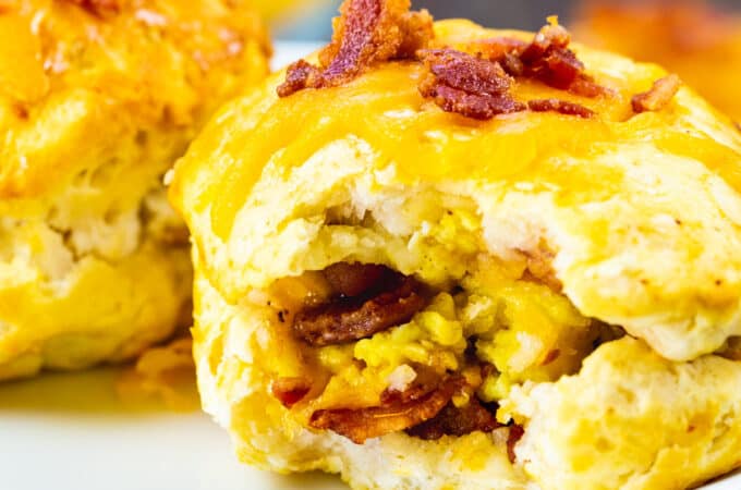 Air Fryer Bacon Egg & Cheese Biscuits Bombs with bite bitten to show inside.