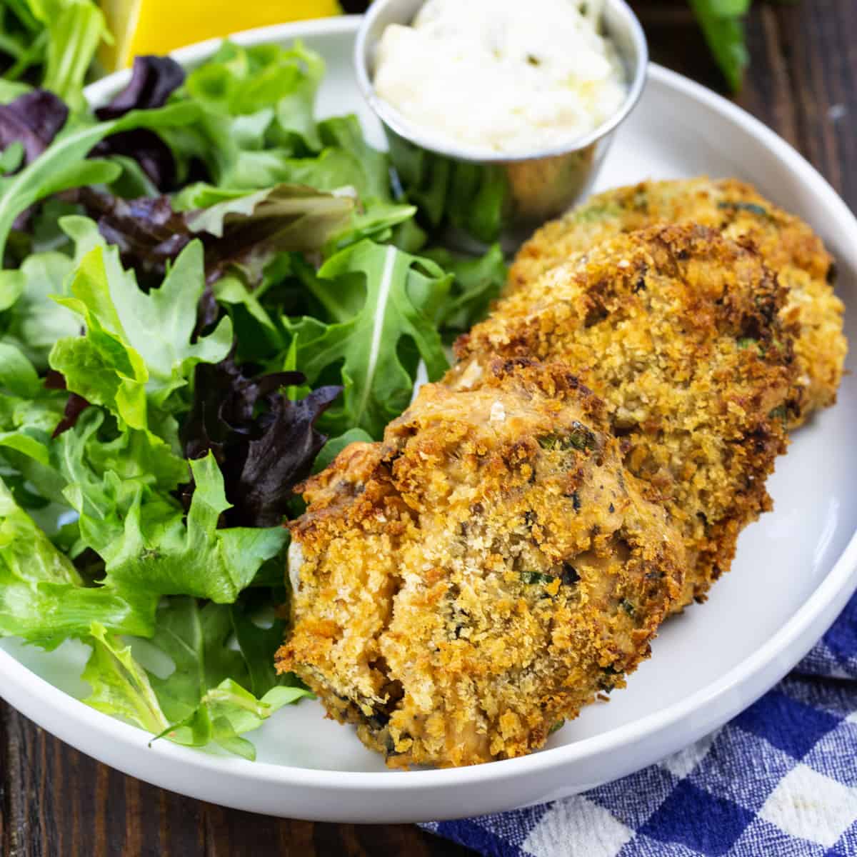 Three Air Fryer Southern Salmon Patties on a plate with salad.