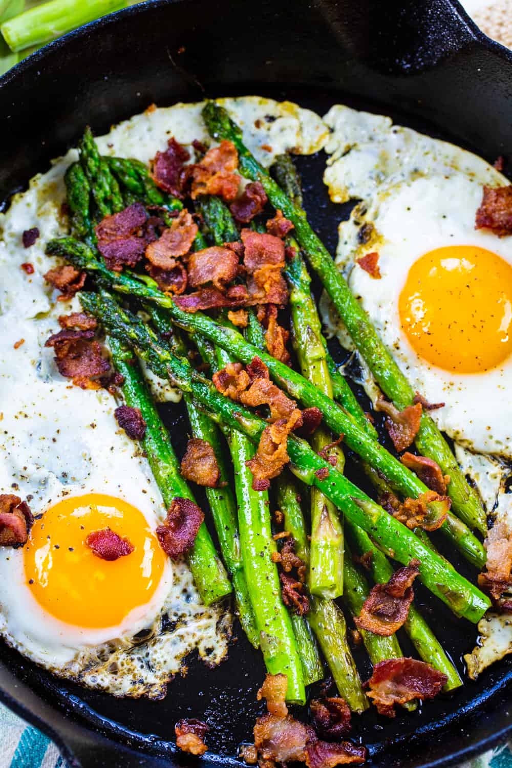 One Pan Bacon, Asparagus, and Egg Breakfast in cast iron pan.