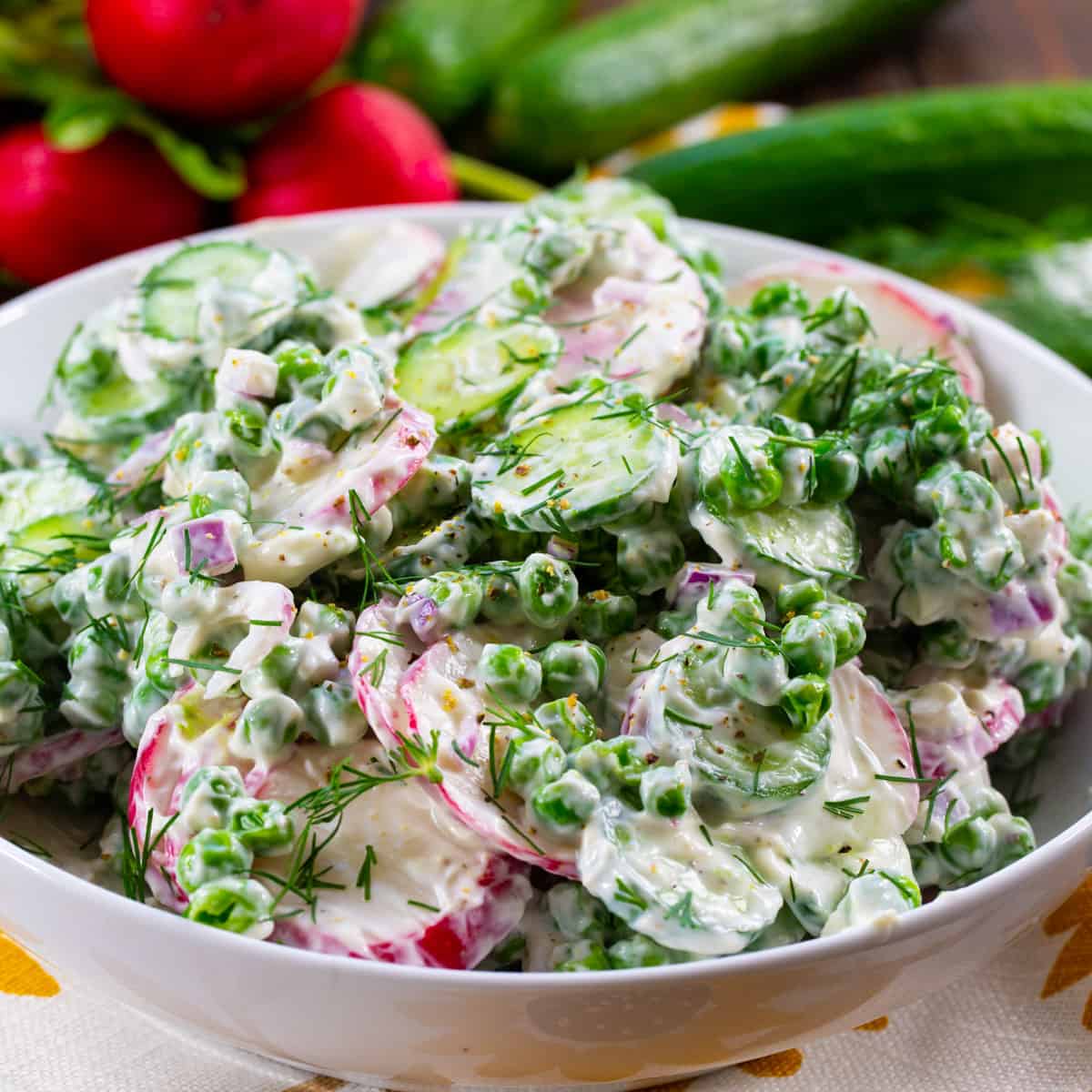 Pea, Cucumber and Radish Salad in a white bowl.