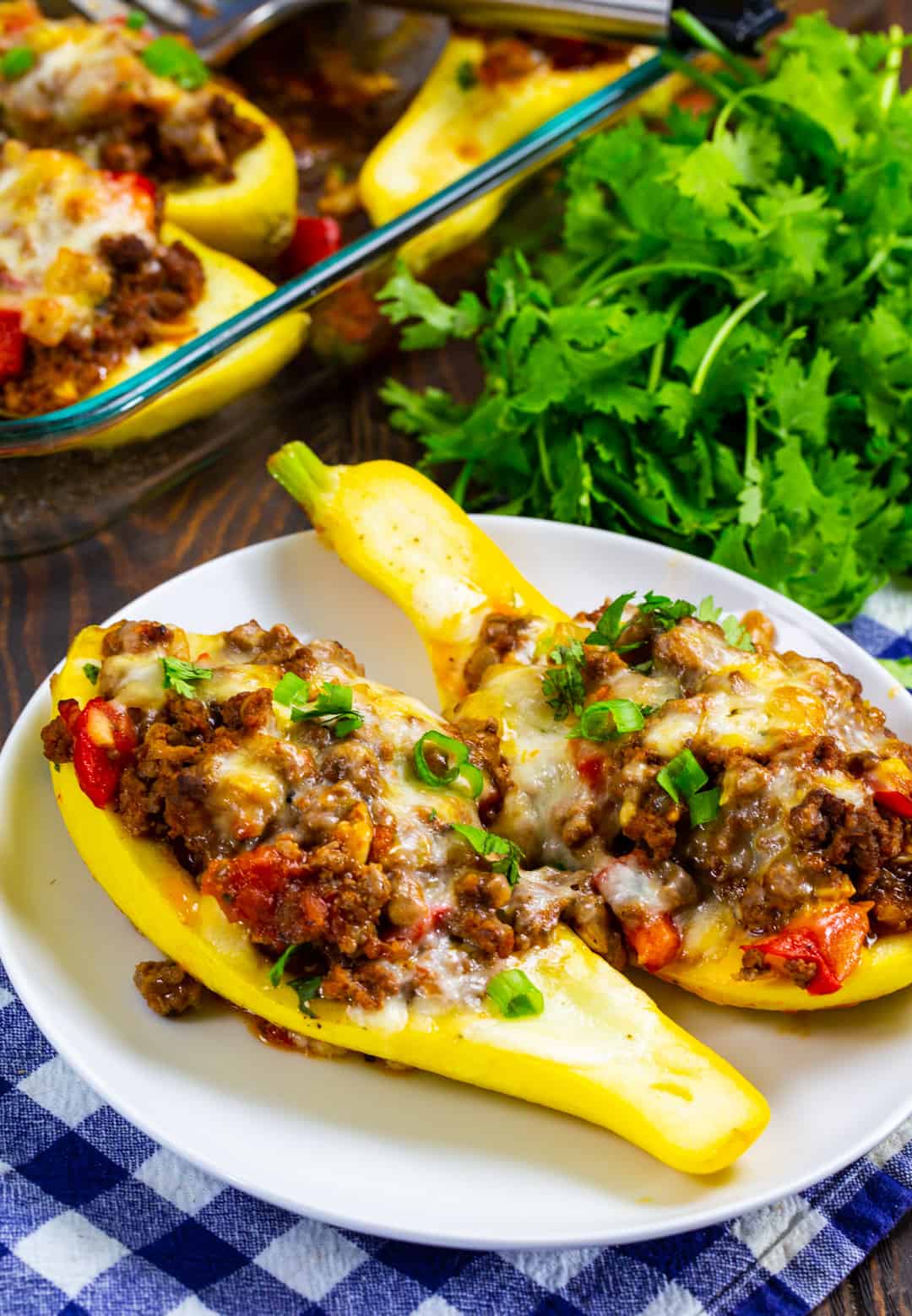 Two Taco Stuffed Summer Squash on a plate.