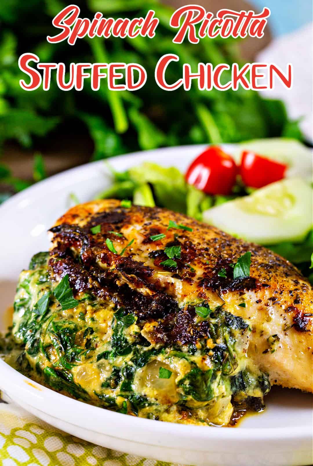 Spinach Ricotta Stuffed Chicken on a plate with salad.